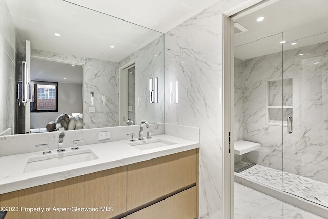 bathroom featuring vanity and an enclosed shower