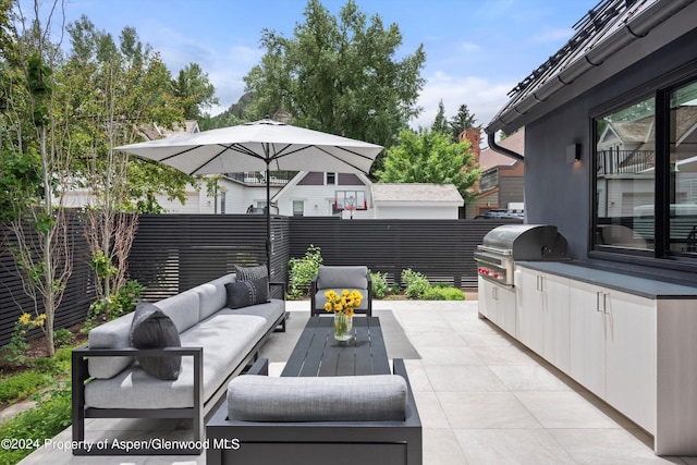 view of patio featuring outdoor lounge area, an outdoor kitchen, and a grill