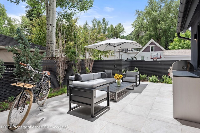 view of patio with outdoor lounge area and exterior kitchen