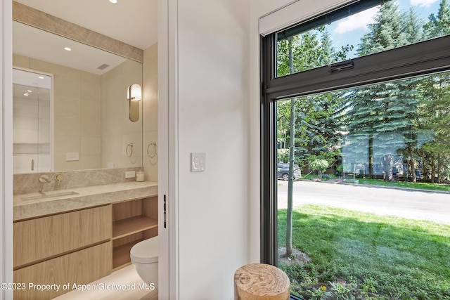 bathroom featuring vanity and toilet