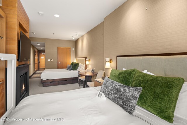 130 Wood Road 306 & 308, Snowmass Village, CO 81615 - bedroom featuring a glass covered fireplace, wallpapered walls, and carpet floors