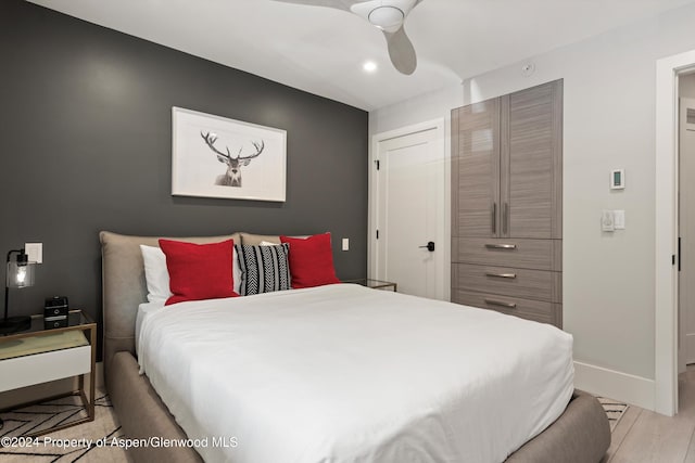 bedroom with ceiling fan and light wood-type flooring