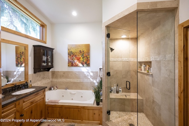 bathroom with vanity and plus walk in shower