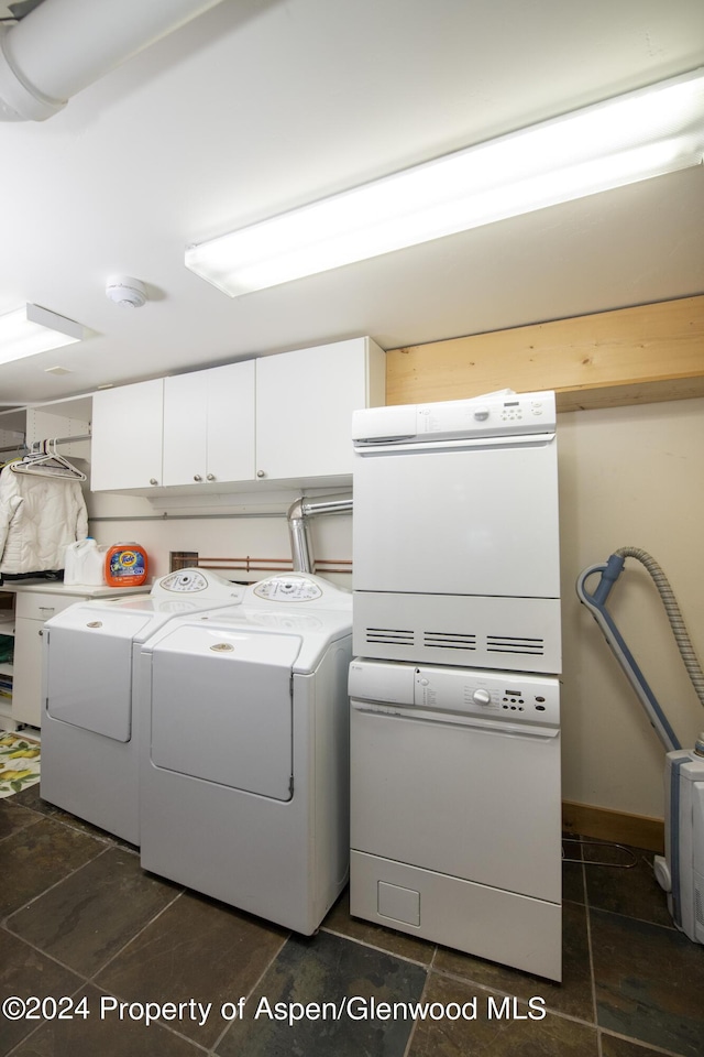 washroom with cabinets and washer and dryer