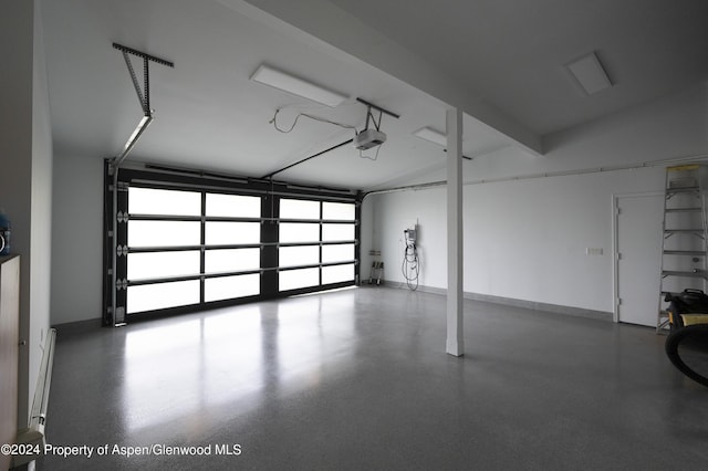 garage with a garage door opener and a baseboard radiator