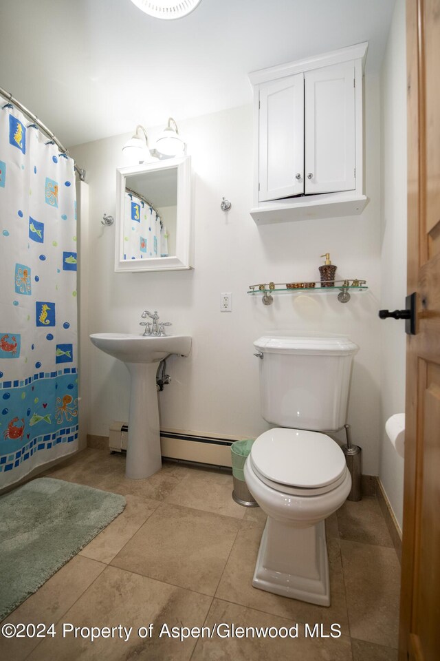 bathroom with tile patterned flooring, toilet, a shower with shower curtain, and a baseboard radiator