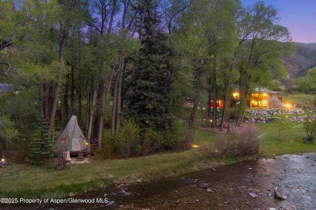 2134 Lower River Rd, Snowmass, CO 81654 - view of grassy yard with a fire pit