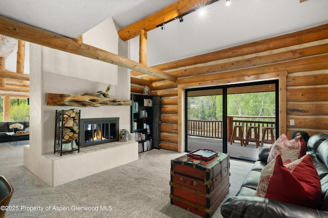 2134 Lower River Rd, Snowmass, CO 81654 - carpeted living room with log walls, a tile fireplace, rail lighting, plenty of natural light, and high vaulted ceiling