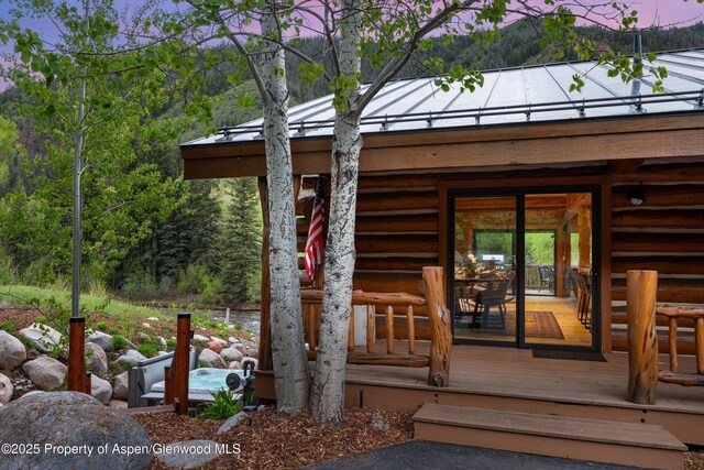 2134 Lower River Rd, Snowmass, CO 81654 - property entrance with metal roof, a standing seam roof, and a wooden deck