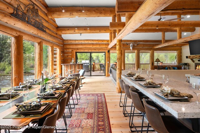 2134 Lower River Rd, Snowmass, CO 81654 - dining space featuring beamed ceiling, light wood-style floors, and rustic walls