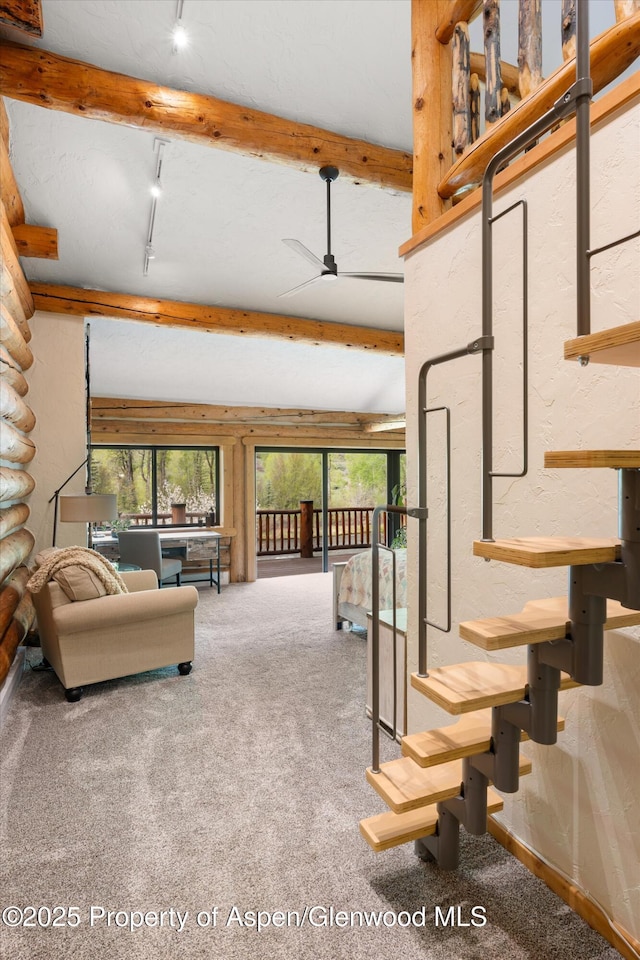 2134 Lower River Rd, Snowmass, CO 81654 - carpeted living room featuring healthy amount of natural light, beam ceiling, a ceiling fan, and rail lighting