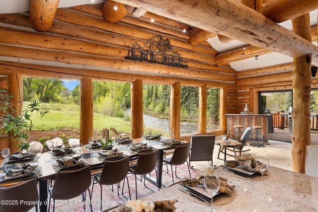 2134 Lower River Rd, Snowmass, CO 81654 - dining room with healthy amount of natural light, wood finished floors, and log walls