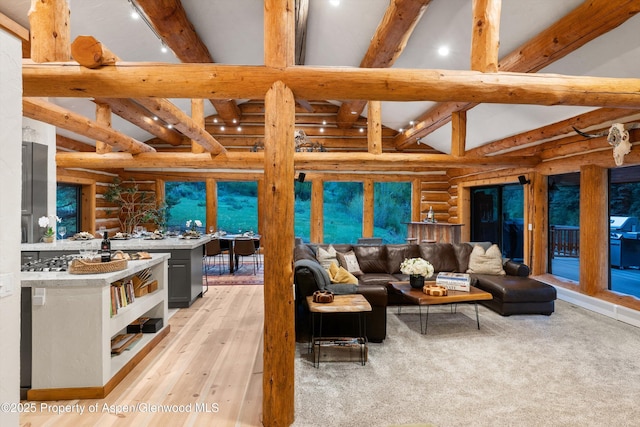 2134 Lower River Rd, Snowmass, CO 81654 - living area with log walls, beamed ceiling, light wood-type flooring, recessed lighting, and high vaulted ceiling