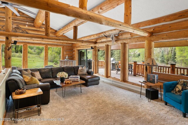 2134 Lower River Rd, Snowmass, CO 81654 - living area with carpet, log walls, beam ceiling, a ceiling fan, and high vaulted ceiling