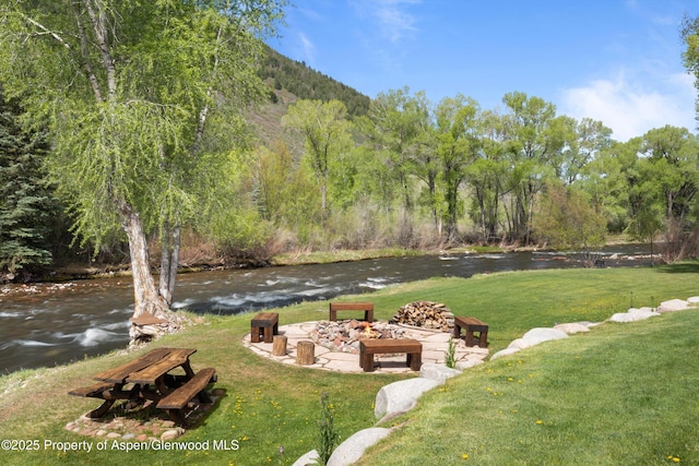 2134 Lower River Rd, Snowmass, CO 81654 - view of green lawn featuring an outdoor fire pit