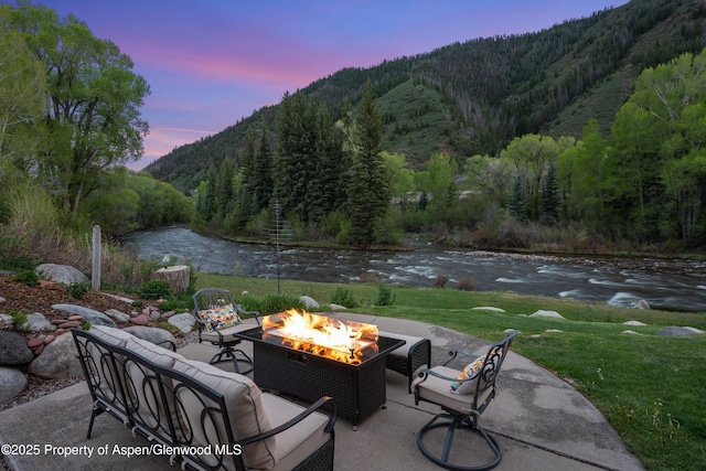2134 Lower River Rd, Snowmass, CO 81654 - view of patio / terrace featuring a wooded view, a water and mountain view, and an outdoor living space with a fire pit