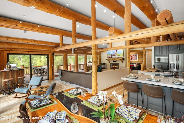2134 Lower River Rd, Snowmass, CO 81654 - dining area featuring healthy amount of natural light, beam ceiling, recessed lighting, light wood-style floors, and rustic walls