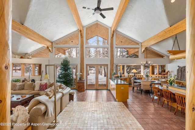 living room featuring high vaulted ceiling, ceiling fan with notable chandelier, tile patterned floors, french doors, and beamed ceiling