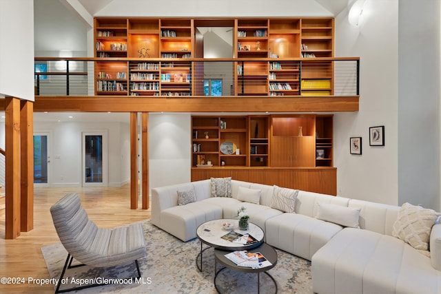 living room featuring light hardwood / wood-style flooring and high vaulted ceiling