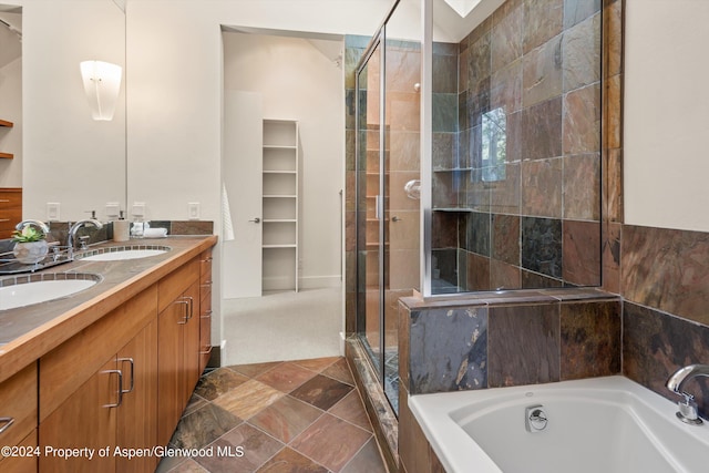 bathroom with vanity and independent shower and bath