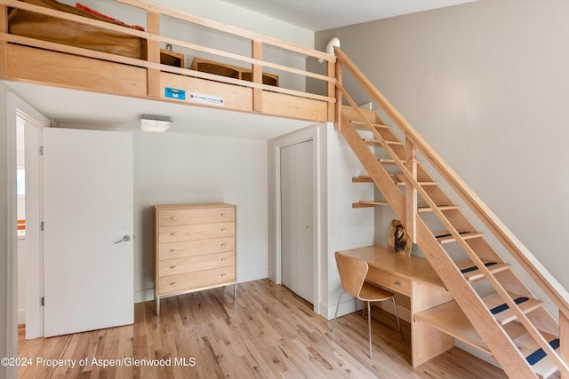 stairs featuring hardwood / wood-style floors