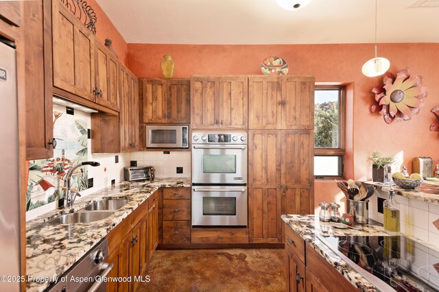 1212 County Road 238th Rd Unit 238, Silt, CO 81652 - kitchen featuring stainless steel appliances, a sink, brown cabinetry, and backsplash