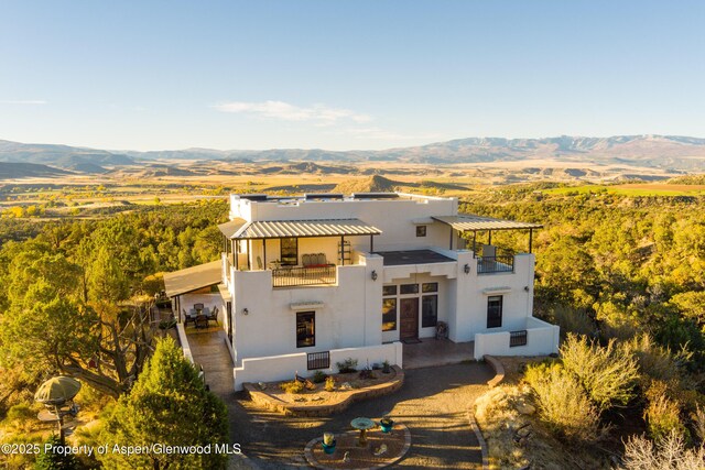 1212 County Road 238th Rd Unit 238, Silt, CO 81652 - view of front of home featuring a balcony, stucco siding, a mountain view, and a standing seam roof