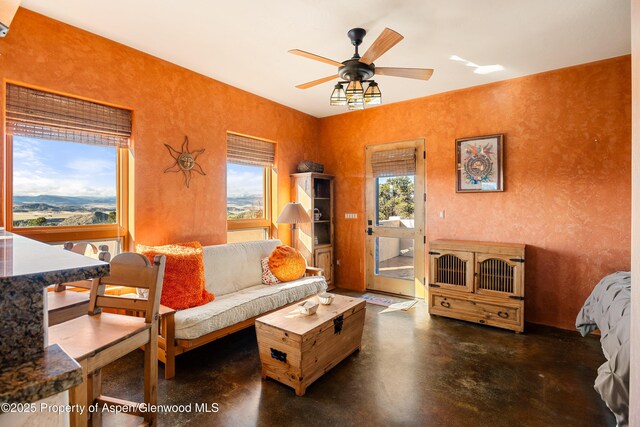 1212 County Road 238th Rd Unit 238, Silt, CO 81652 - living room featuring concrete floors, plenty of natural light, ceiling fan, and a textured wall