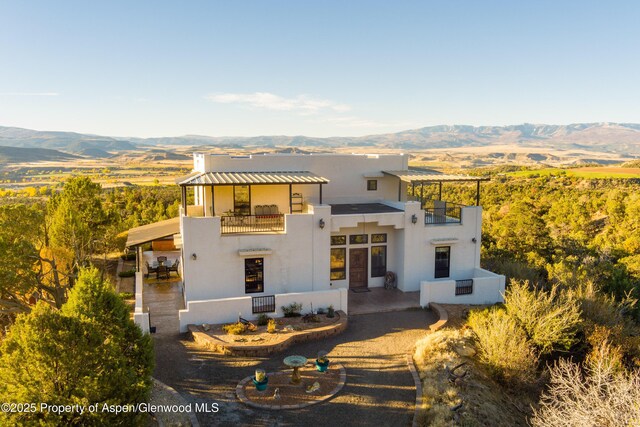 1212 County Road 238th Rd Unit 238, Silt, CO 81652 - view of front of house featuring a balcony, stucco siding, and a mountain view