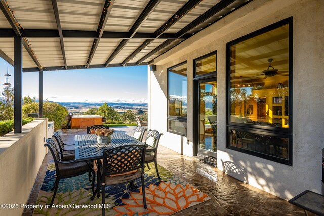 1212 County Road 238th Rd Unit 238, Silt, CO 81652 - view of patio featuring a hot tub, outdoor dining space, and a mountain view