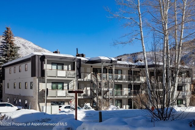 100 E Dean St Unit 1B, Aspen, CO 81611 - snow covered property with a view of apartment building / complex and a mountain view