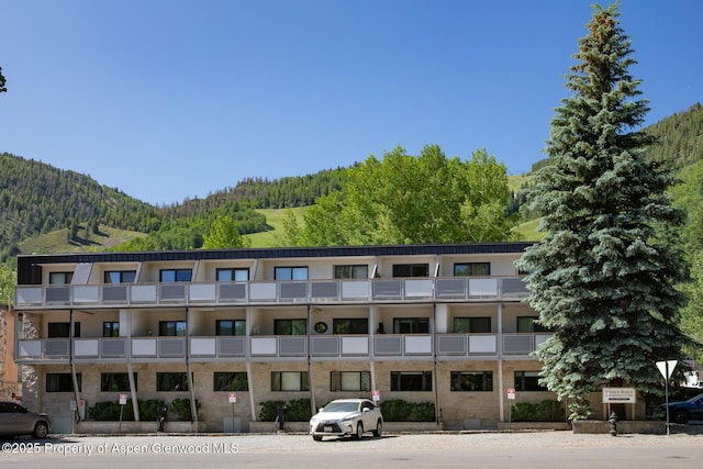 100 E Dean St Unit 1B, Aspen, CO 81611 - view of building exterior featuring a mountain view and a view of trees