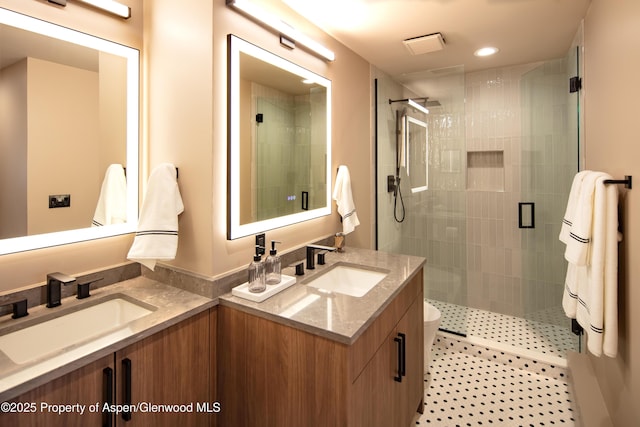 100 E Dean St Unit 1B, Aspen, CO 81611 - bathroom featuring double vanity, a shower stall, and recessed lighting