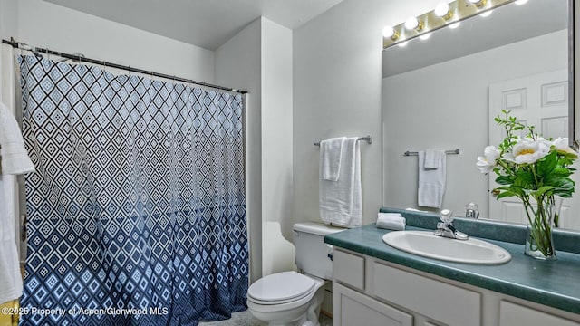 bathroom featuring toilet and vanity