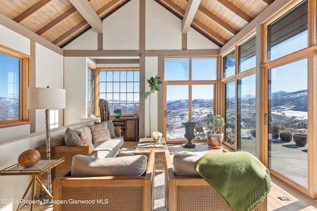 sunroom / solarium with a mountain view, vaulted ceiling with beams, and wood ceiling