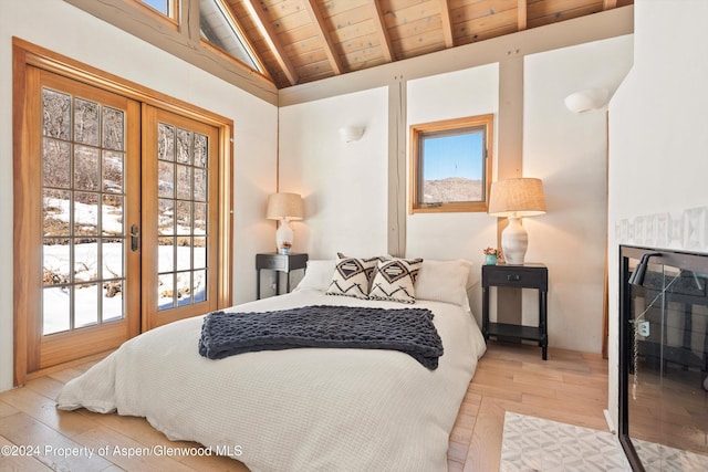 bedroom with multiple windows, wooden ceiling, french doors, and light hardwood / wood-style floors