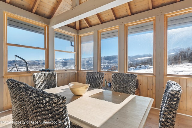 interior space with lofted ceiling with beams, a mountain view, and wooden ceiling