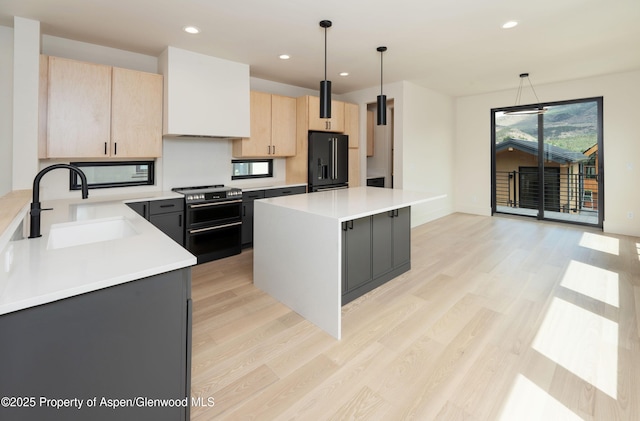 366 Stotts Mill Rd, Basalt, CO 81621 - kitchen featuring light brown cabinetry, range with two ovens, light wood-style floors, light countertops, and recessed lighting