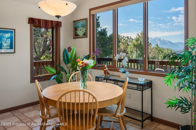10 Cedar Cv, Glenwood Springs, CO 81601 - dining space with healthy amount of natural light, a mountain view, and light tile patterned flooring