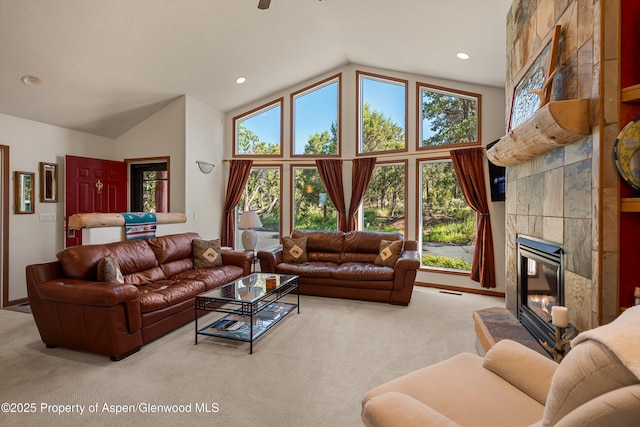 10 Cedar Cv, Glenwood Springs, CO 81601 - living room featuring carpet floors, a tiled fireplace, high vaulted ceiling, and recessed lighting