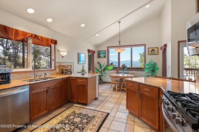 10 Cedar Cv, Glenwood Springs, CO 81601 - kitchen featuring stainless steel appliances, brown cabinets, a peninsula, recessed lighting, and high vaulted ceiling