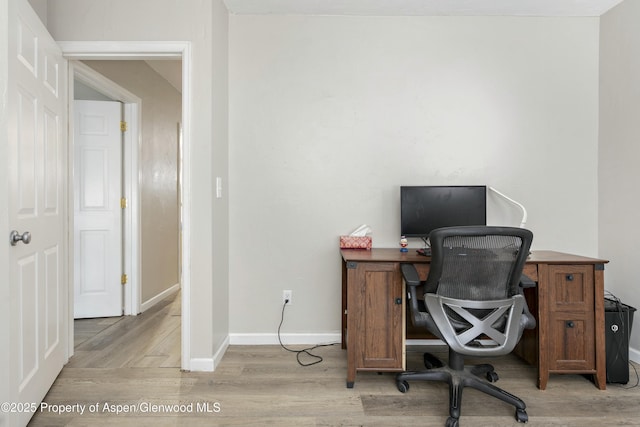 office area featuring light wood-style flooring and baseboards