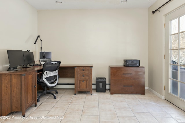 office featuring light tile patterned floors, baseboard heating, and baseboards