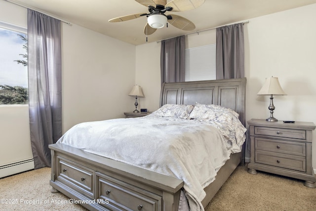 bedroom with light carpet, baseboard heating, and ceiling fan