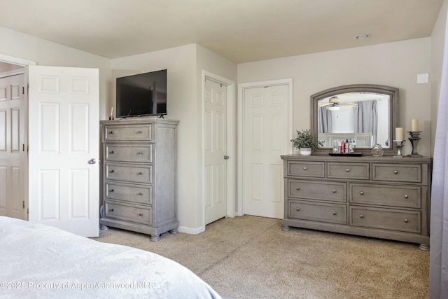 bedroom featuring baseboards and light carpet