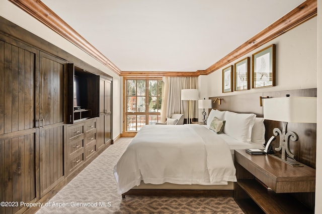 bedroom featuring carpet floors and crown molding