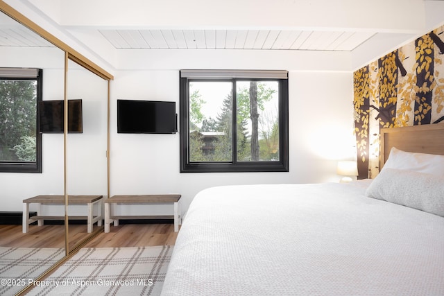 901 E Hyman Ave Unit 4, Aspen, CO 81611 - bedroom with light wood-style flooring, a closet, and wood ceiling with exposed beams
