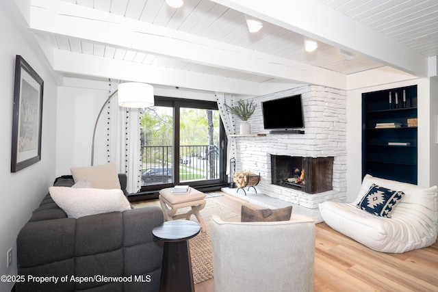 901 E Hyman Ave Unit 4, Aspen, CO 81611 - living room featuring wood finished floors, a fireplace, and wooden ceiling with exposed beams