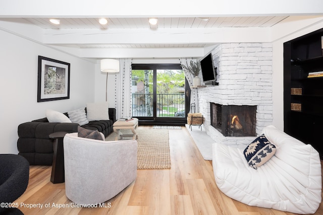 901 E Hyman Ave Unit 4, Aspen, CO 81611 - living area with a stone fireplace, wood finished floors, and wood ceiling with exposed beams