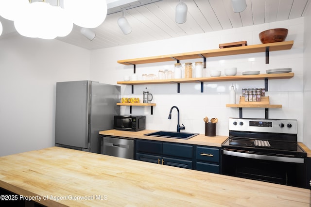 901 E Hyman Ave Unit 4, Aspen, CO 81611 - kitchen with a sink, stainless steel appliances, butcher block counters, blue cabinetry, and open shelves